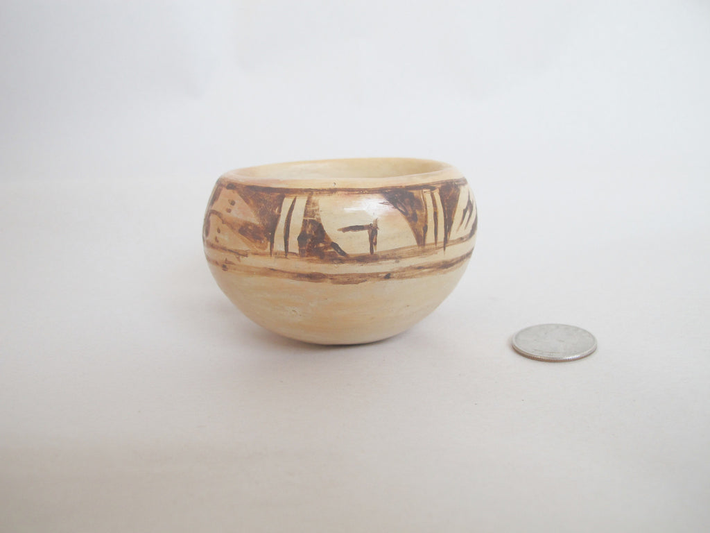 Authentic, hand-coiled, natural clay and slip, traditional designs.  Low-fired in a wood fire, on the ground.  Each is one-of-a-kind, the real thing.  3¼ wide x 2 high, 2¼" mouth.